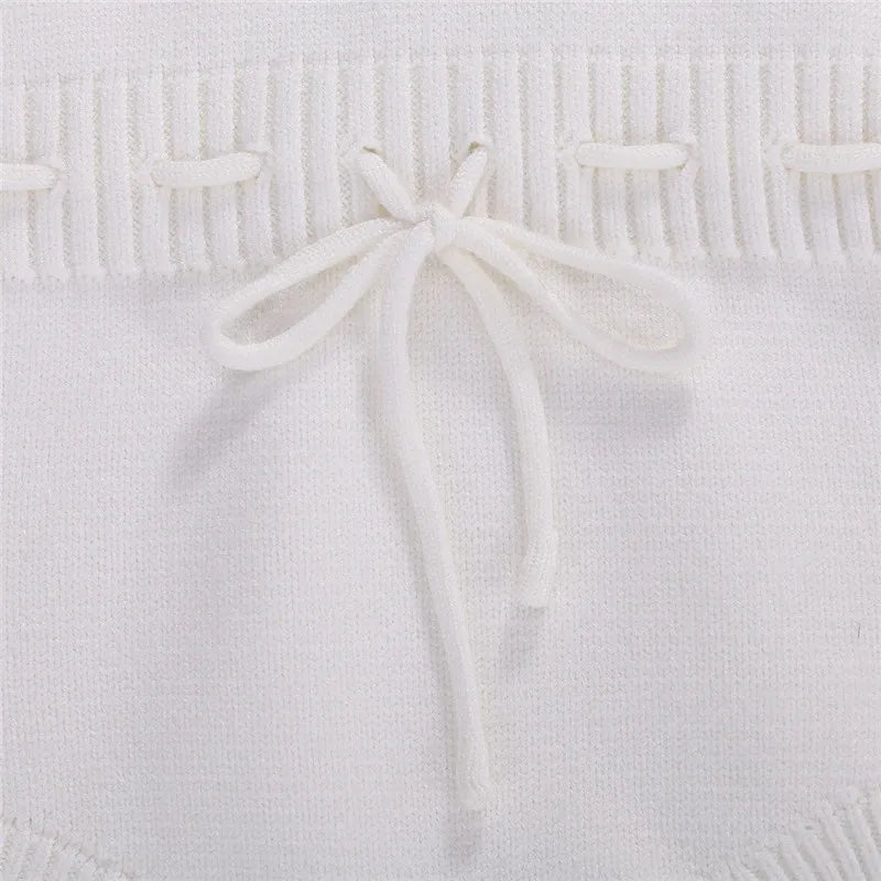 Baby Girl Ruffle Knit Onesie in white - closeup of tie details