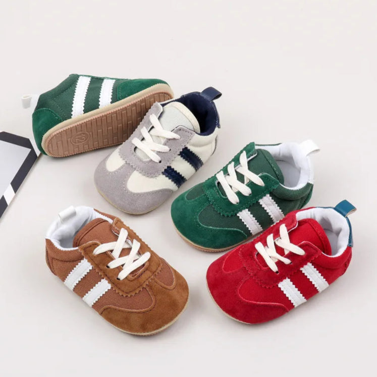 Classic stripe baby sneakers in red, green, grey, and brown.