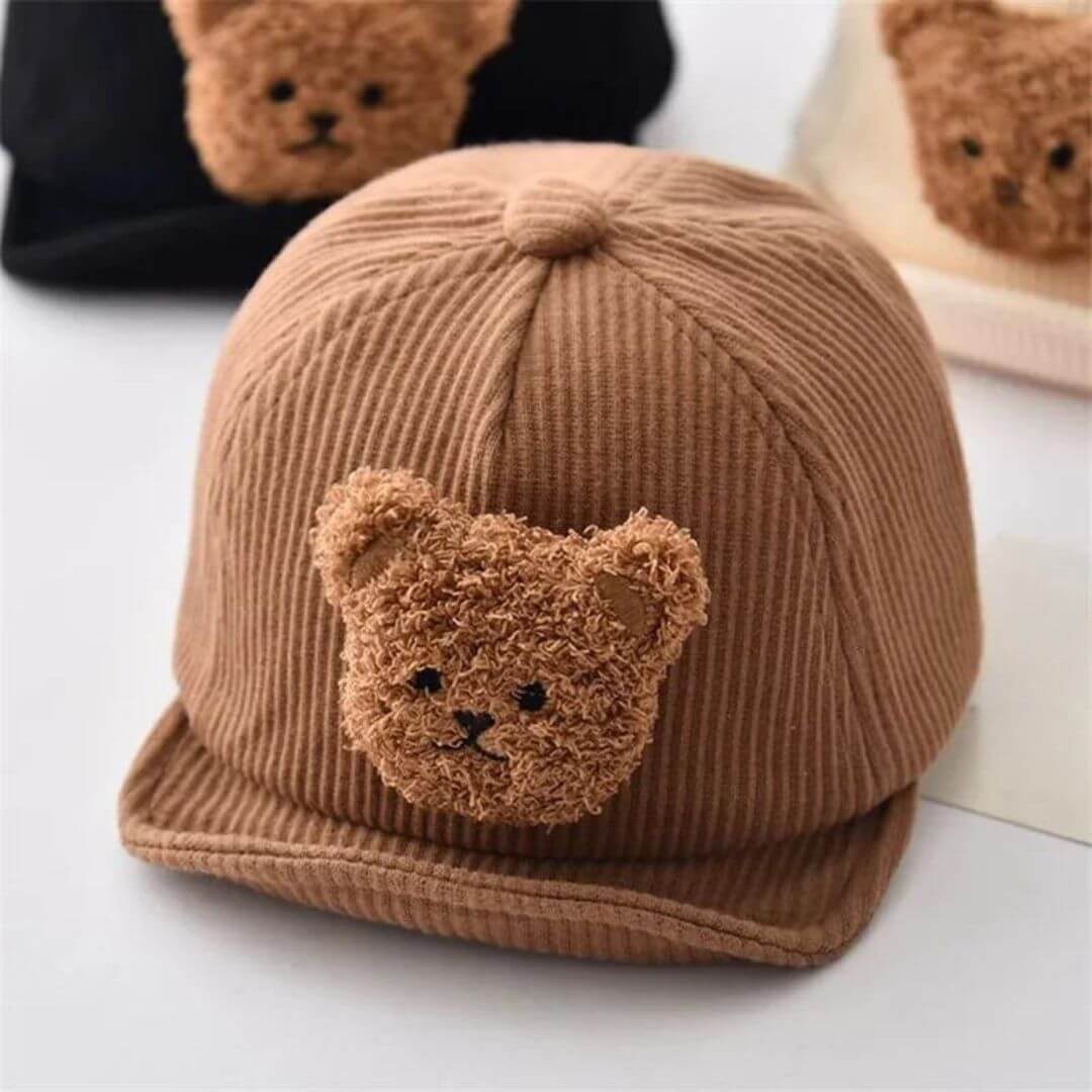 Brown corduroy baby cap with fluffy teddy bear patch