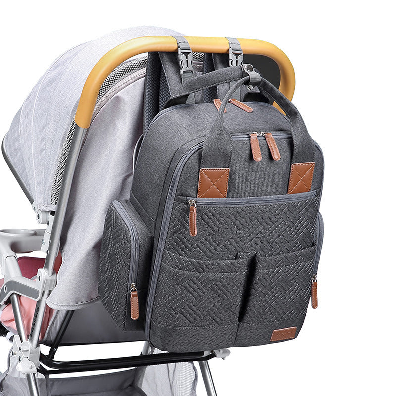 Urban nappy backpack attached to pram with integrated stroller straps