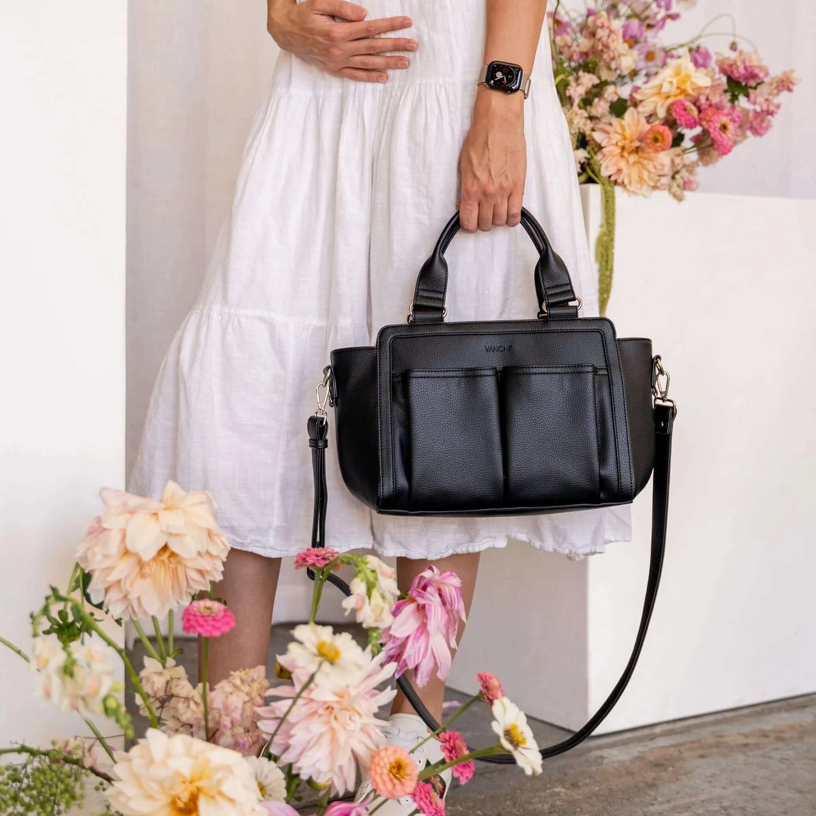 Mum holding stylish VANCHI Amelia convertible pram caddy