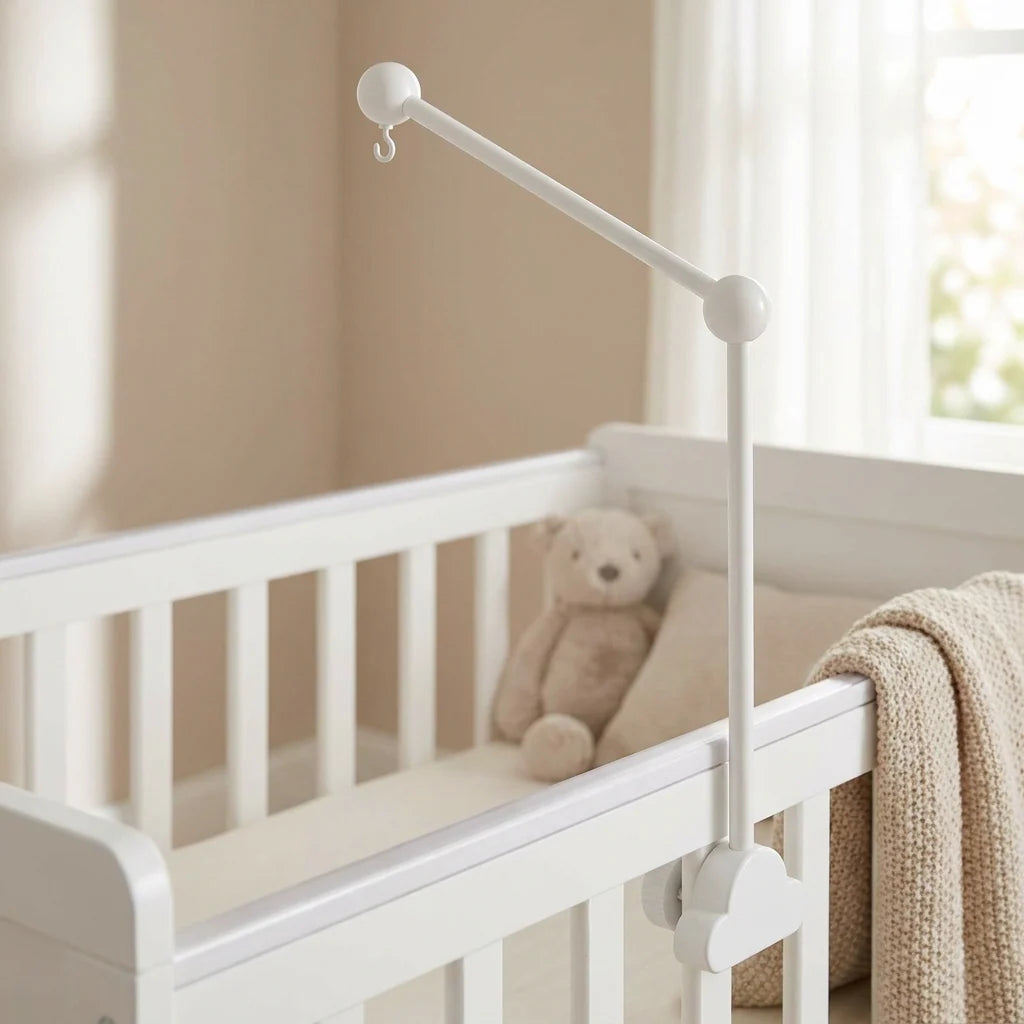 White wooden cloud cot mobile attached to baby cot
