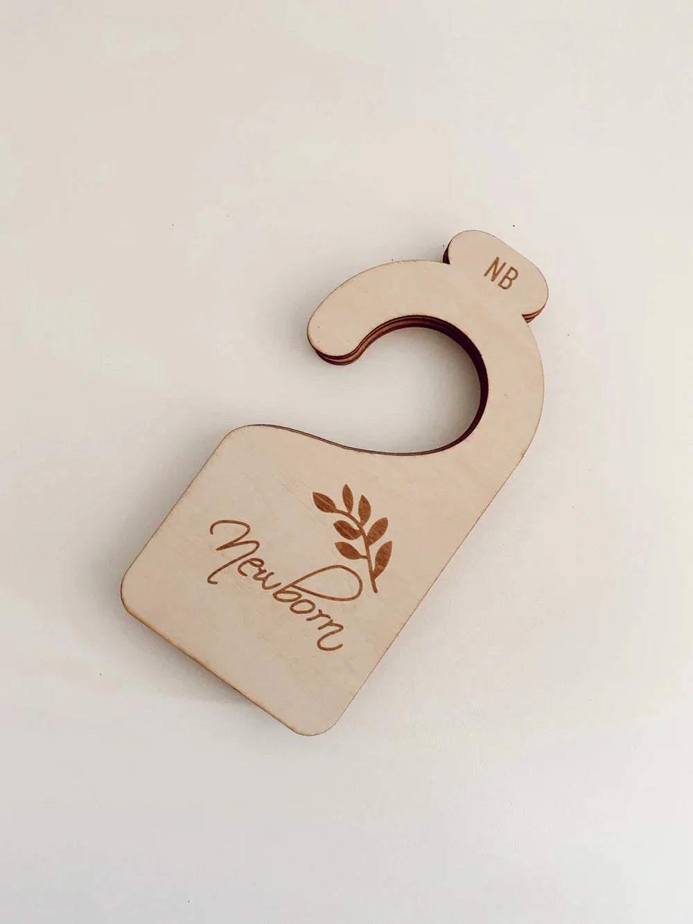 Wooden baby wardrobe divider showing newborn size