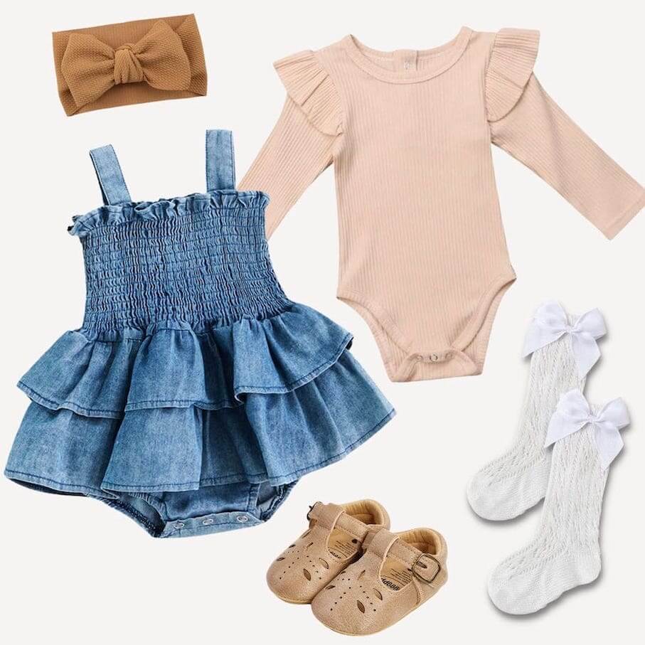 Styled flat lay of baby girl denim peplum ruffle with accessories