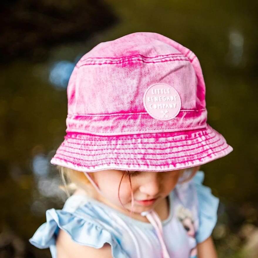 Child wearing pink denim bucket hat by Little Renegade Company