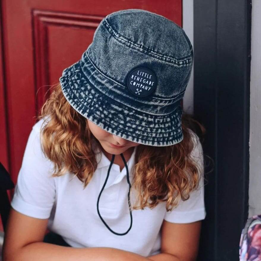 Girl wearing blue Denim Bucket Baby Hat | Little Renegade Company