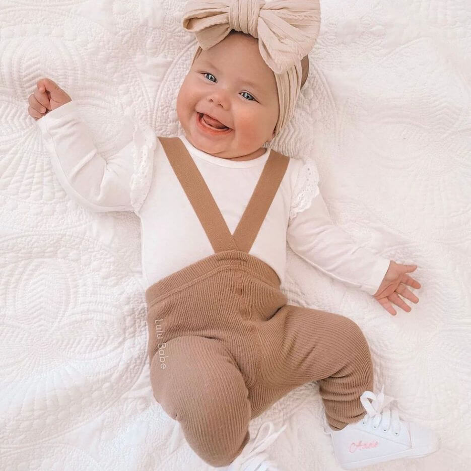 Cute baby girl wearing ribbed suspender tights in latte - from Lulu Babe