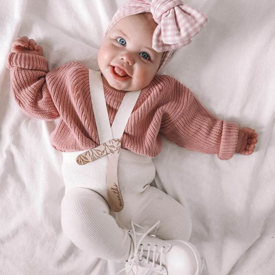 Baby girl wearing creamy white ribbed suspender tights - Lulu Babe