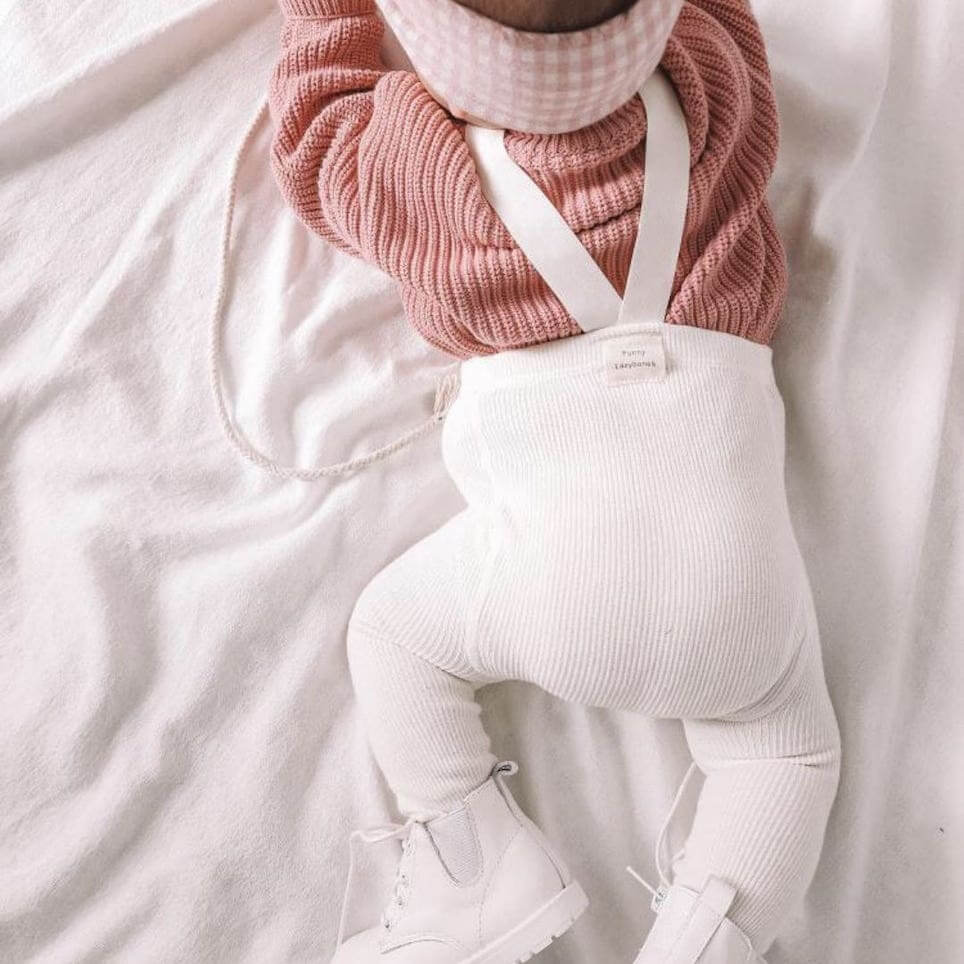 Baby girl wearing creamy white ribbed suspender tights - Lulu Babe