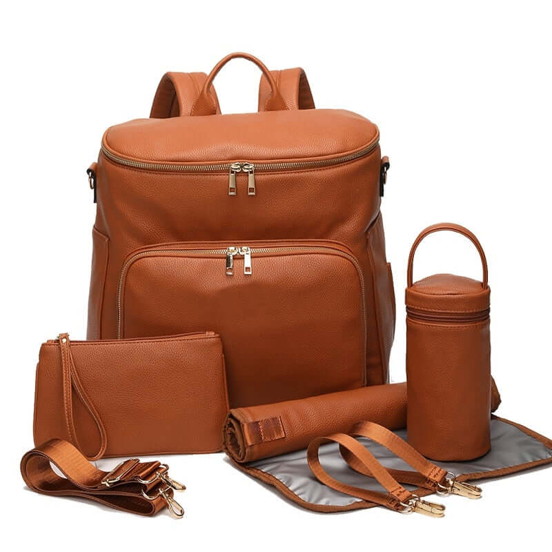 Stylish nappy bag backpack in tan vegan leather with included accessories