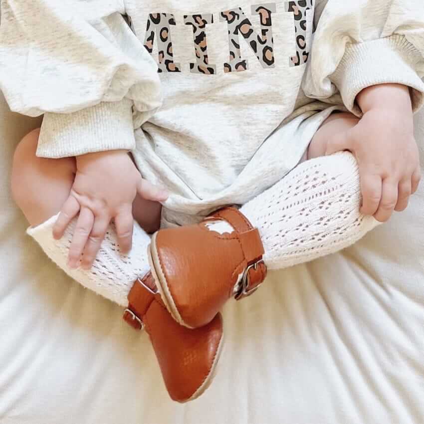 Baby wearing vintage T-Bar Baby Shoes in tan vegan leather from Lulu Babe