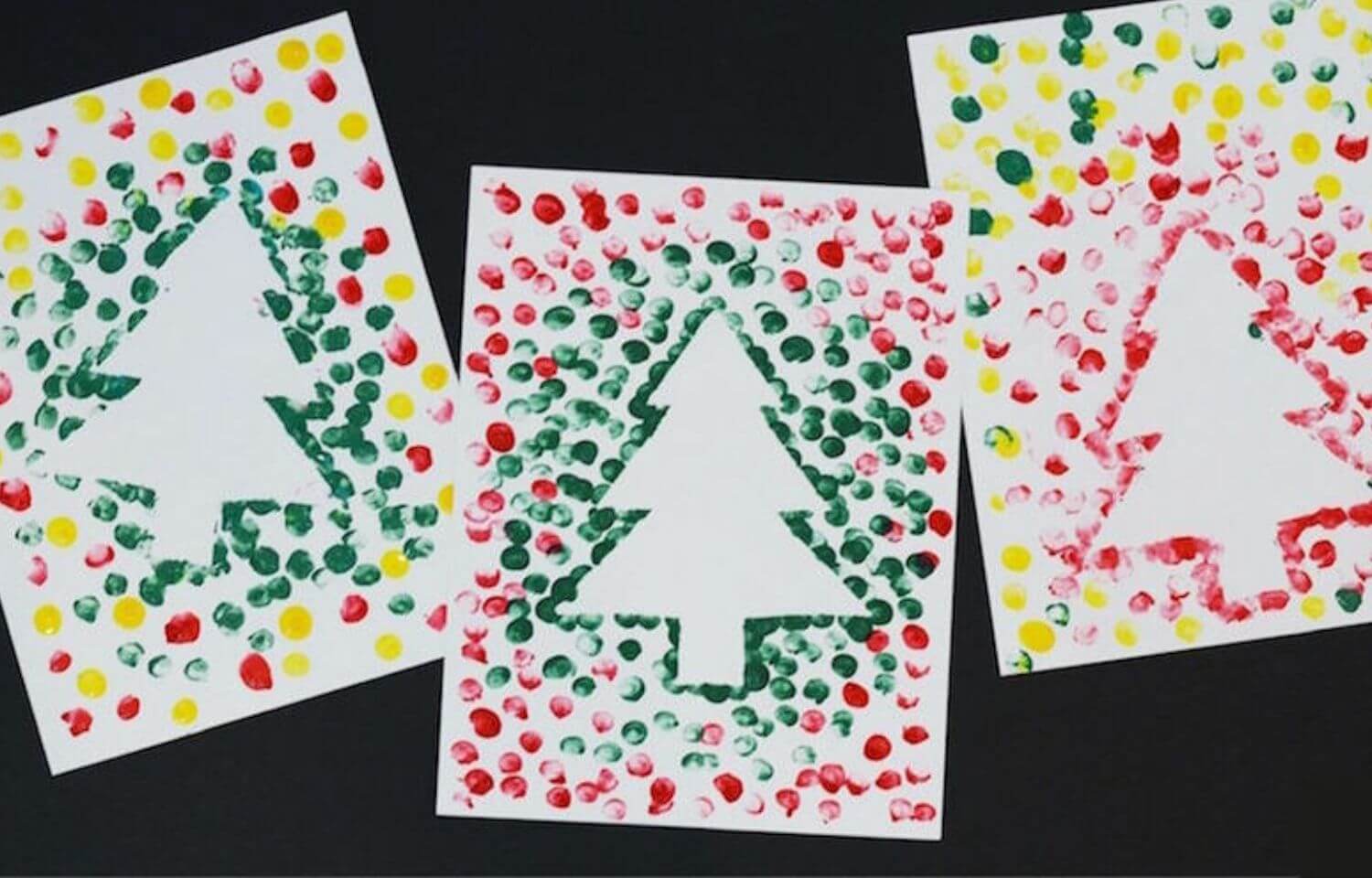 Fun Christmas activities for toddlers, showing fingerprint painting Christmas tree cards