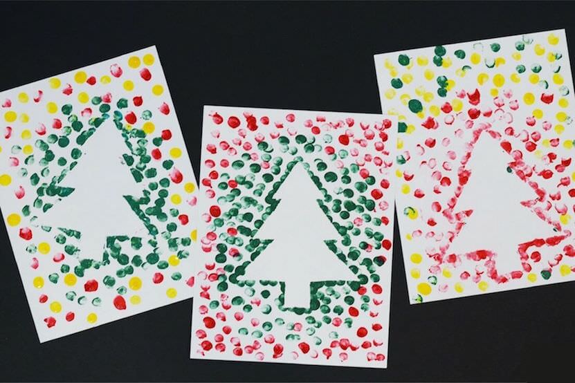 Fun Christmas activities for toddlers, showing fingerprint painting Christmas tree cards