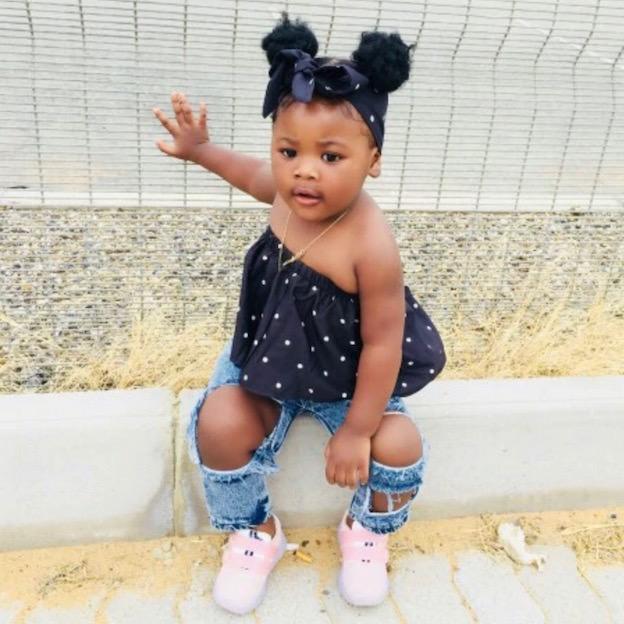 Trendy baby girl outfit - polka dot top and jeans, lifestyle image