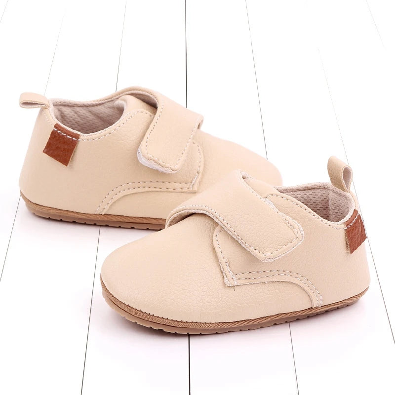 Avery cream vegan leather baby shoes for pre-walkers, featuring flexible rubber sole and velcro strap.