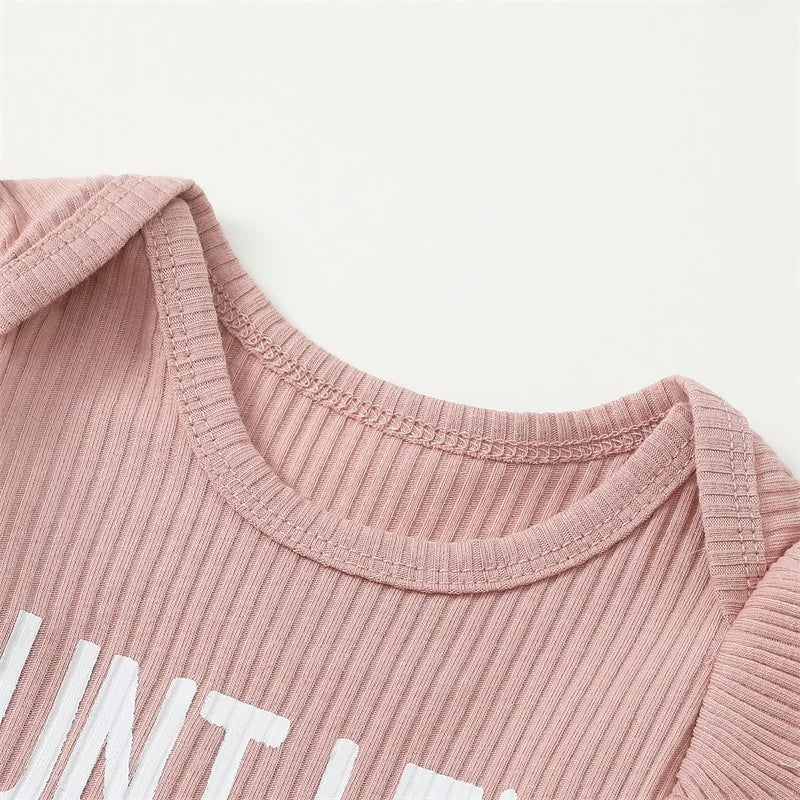 Auntie's Bestie baby girl outfit in pink - closeup of ribbed romper with envelope neckline