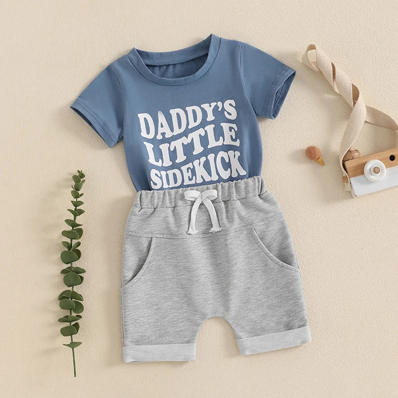 "Daddy's Little Sidekick" baby boy outfit for 0-3 years, featuring soft blue top and comfy grey shorts.