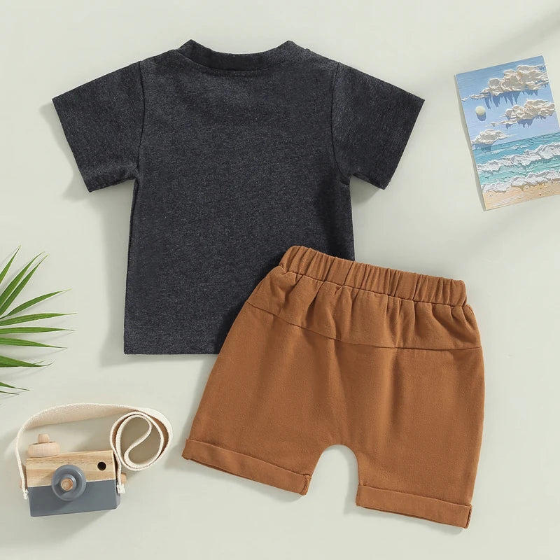 Funny baby outfit - "Cute & Clingy" Slogan T-shirt in black, and brown shorts - back view