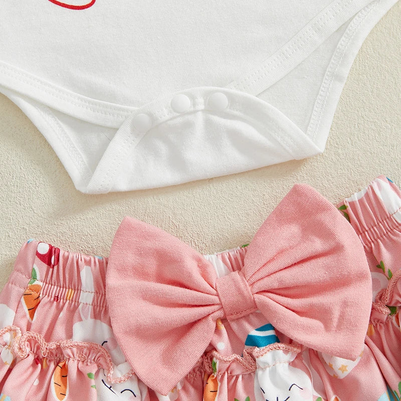 Flatlay of my first Easter baby outfit showing snap fastenings and bow details