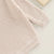 Close-up of textured long-sleeve knit winter romper in sand
