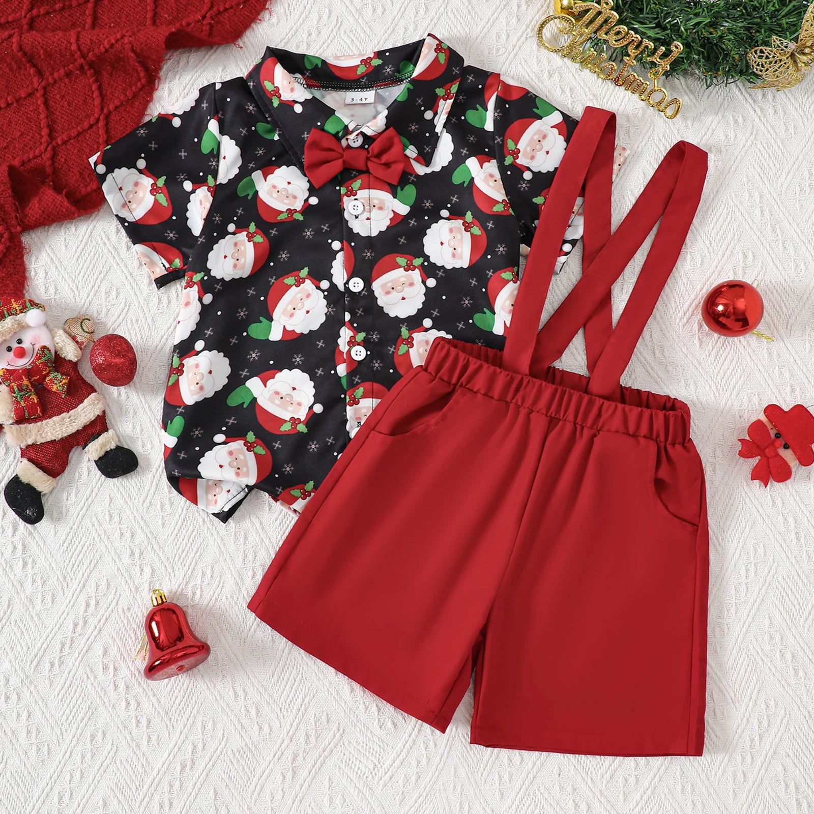 Santa Suspenders Set for baby boy, featuring collared shirt with Santa print, red shorts, and a bow tie.