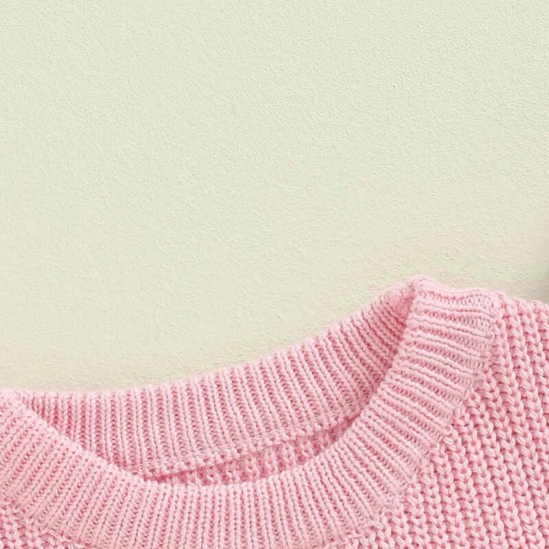 Close-up of the knitted fabric of the Matching Sister Pink Jumper