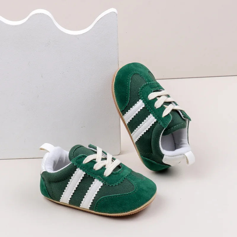 Classic stripe baby sneakers in green with white accents, perfect for stylish little adventures.