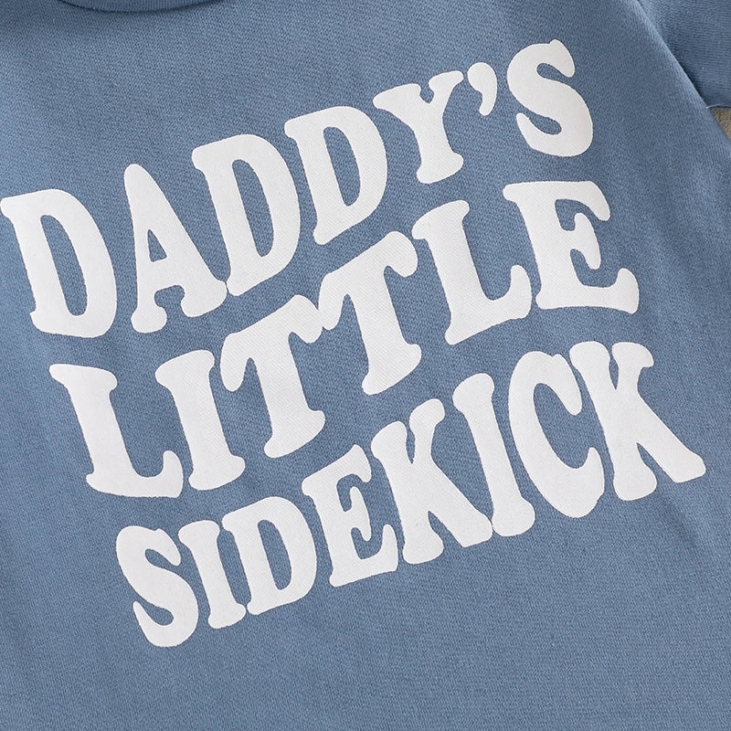 Light blue top featuring bold white text reading 'Daddy's Little Sidekick' for baby boys.