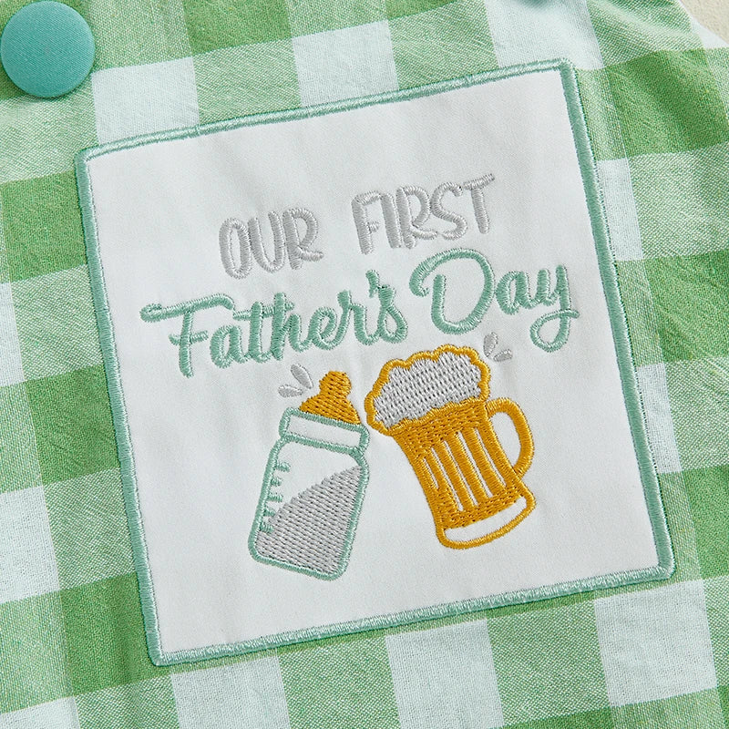 Embroidered patch on gingham romper reading 'Our First Father's Day' with a baby bottle and beer stein design.