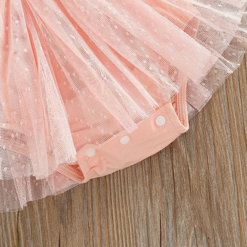 Baby Girl Ballerina Tutu Romper showcasing a soft pink tulle skirt and buttoned romper bottom detail.