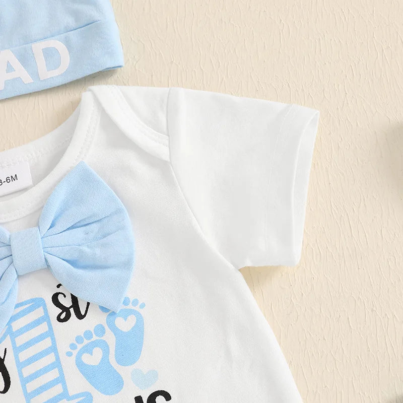 Close-up of My 1st Father's Day bodysuit and beanie hat featuring light blue bow tie and 'I ❤️ DAD' text.