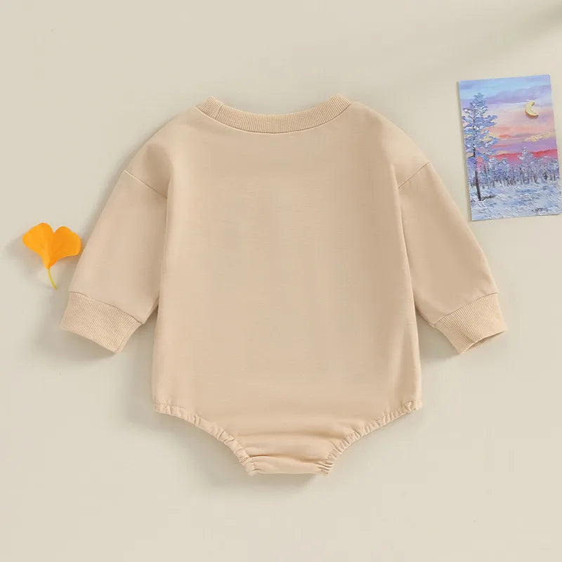Lil Bro Long Sleeve Romper in soft beige, showcasing the back view with long sleeves and relaxed fit.