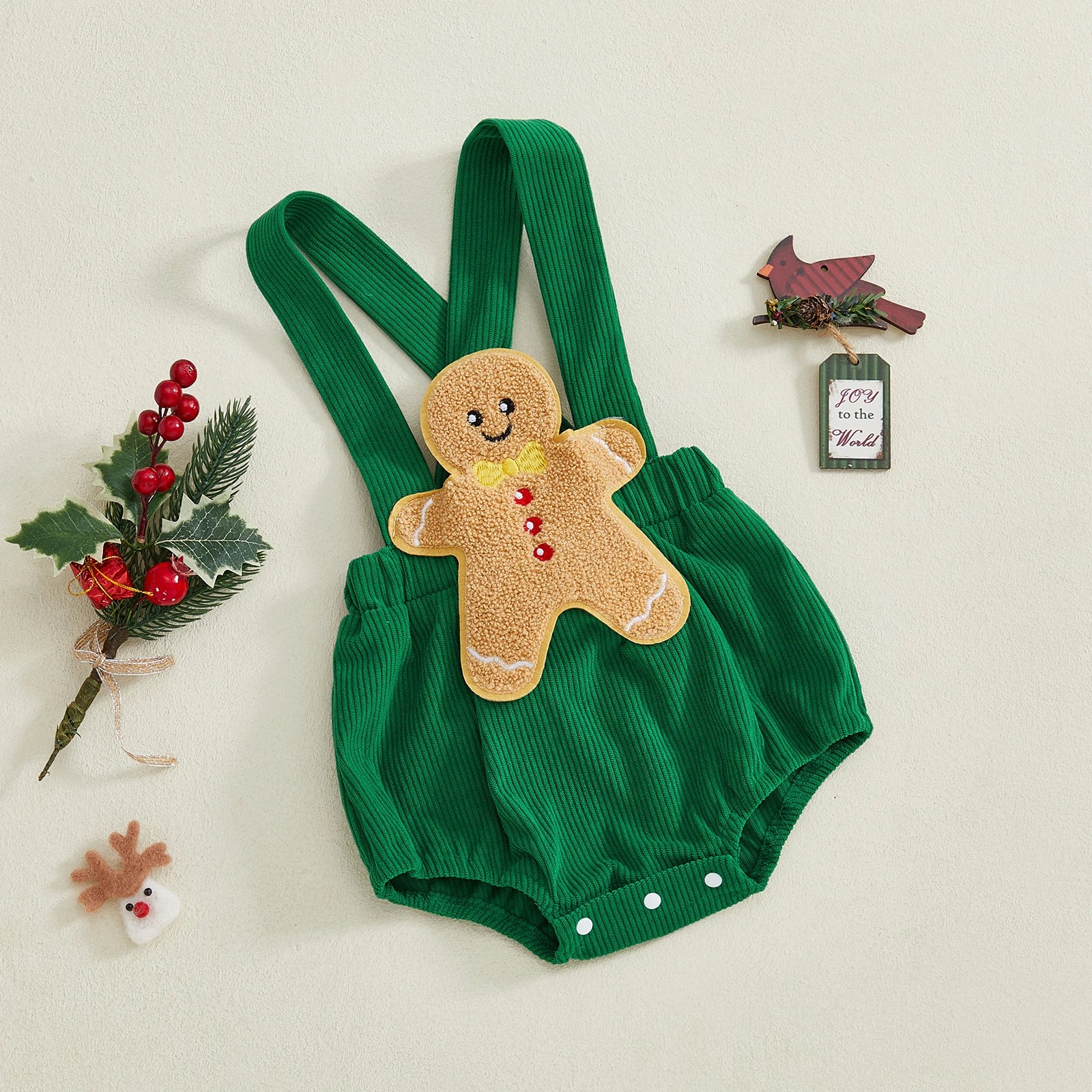 Gingerbread man romper in vibrant green corduroy, ideal Christmas baby outfit for festive celebrations.