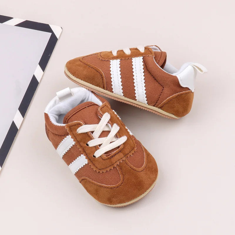 Classic Stripe Baby Sneakers in warm brown with white stripes, perfect for tiny feet aged 0–18 months.