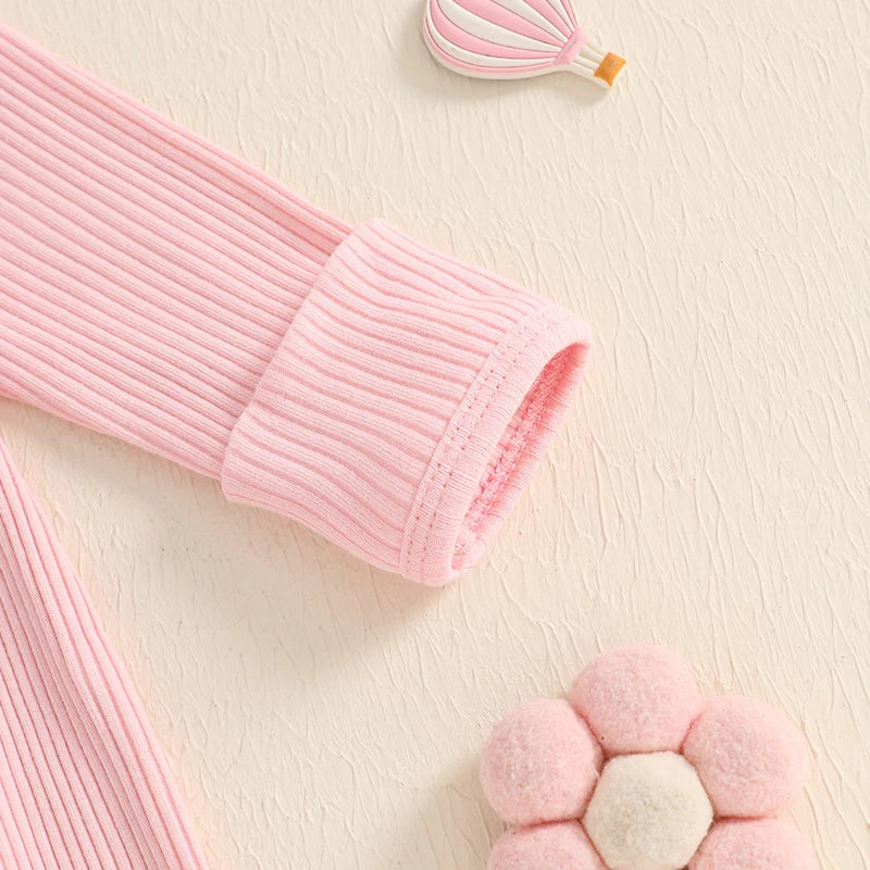 Close-up of the soft pink ribbed sleeve of Daddy’s Girl onesie, showcasing cozy fabric texture and design.