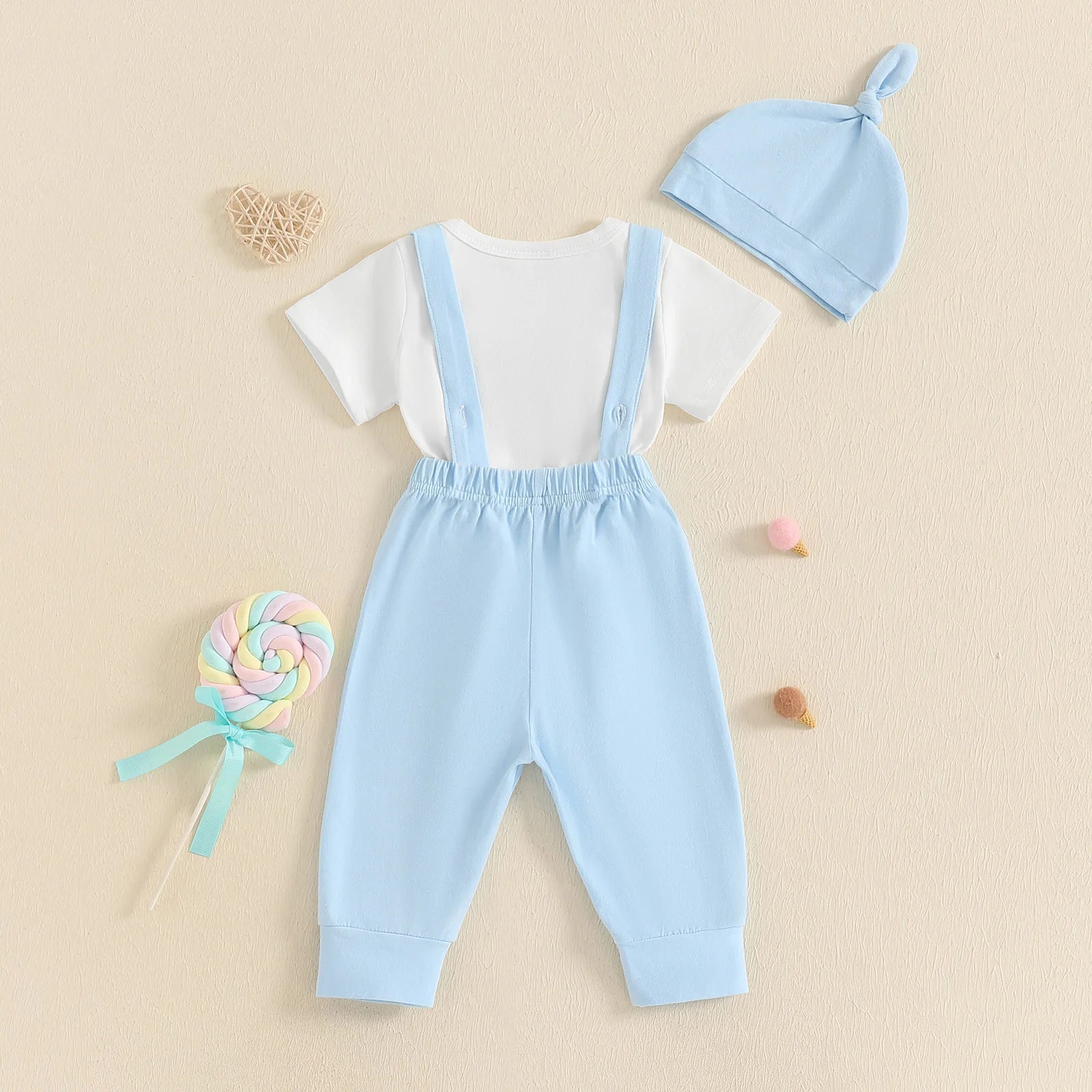 Adorable 1st Father’s Day suspender set with white bodysuit, blue pants, and matching beanie hat