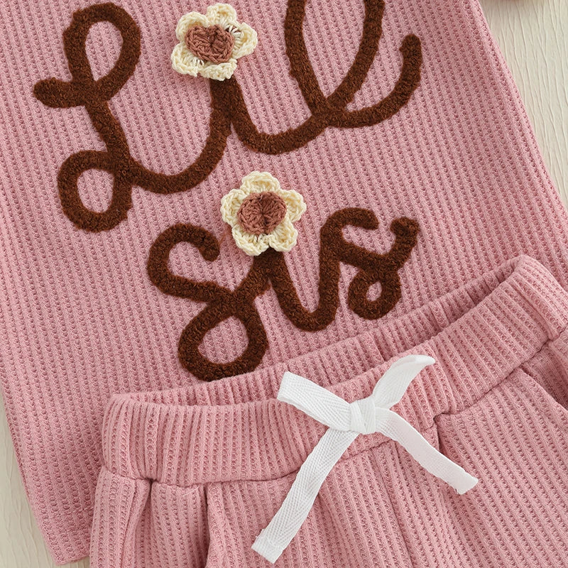 Lil Sis Pink Shorts Set featuring waffle-textured top with floral appliqués and matching shorts.