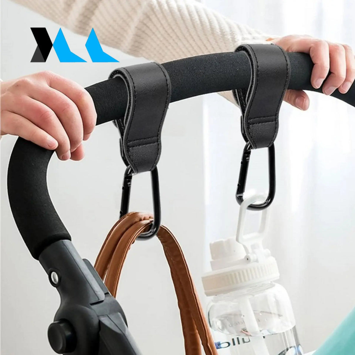 Universal Pram Clips attached to stroller handle, featuring strong velcro, vegan leather