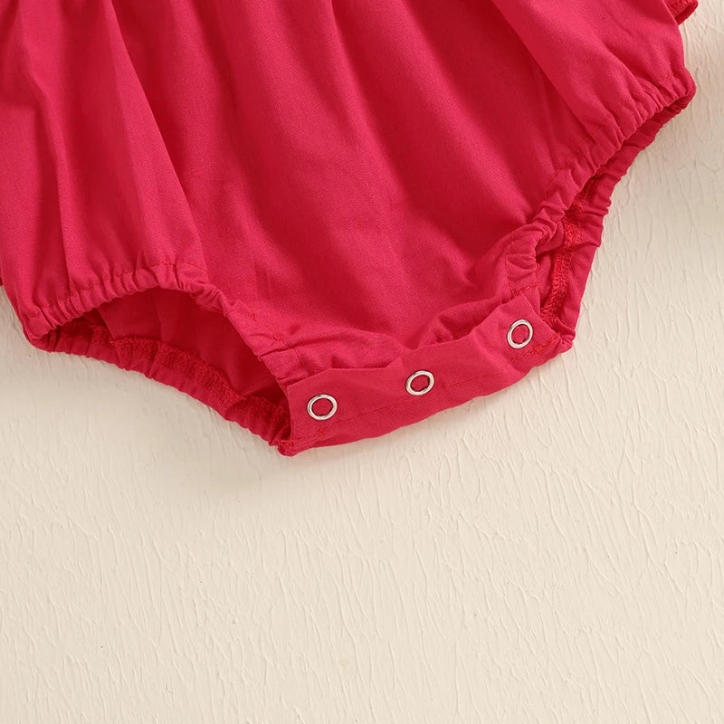Close-up of the snap closures on the Santa Flutter Romper Set for easy changing