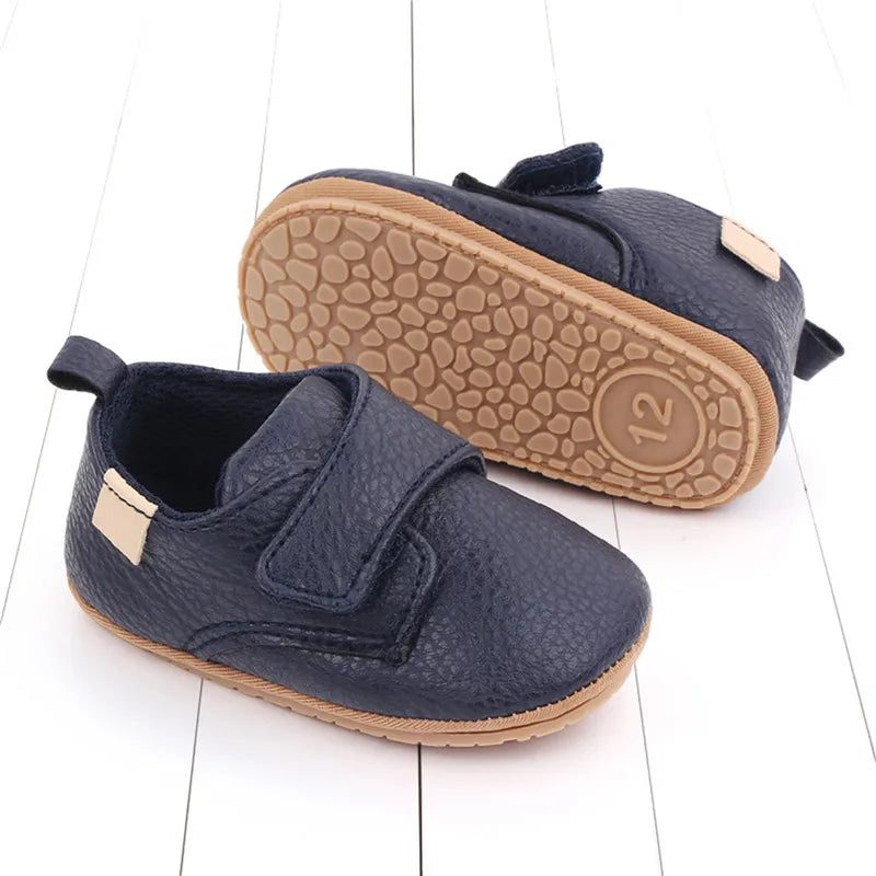Navy vegan leather baby shoes with flexible rubber sole for pre-walkers and early walkers.