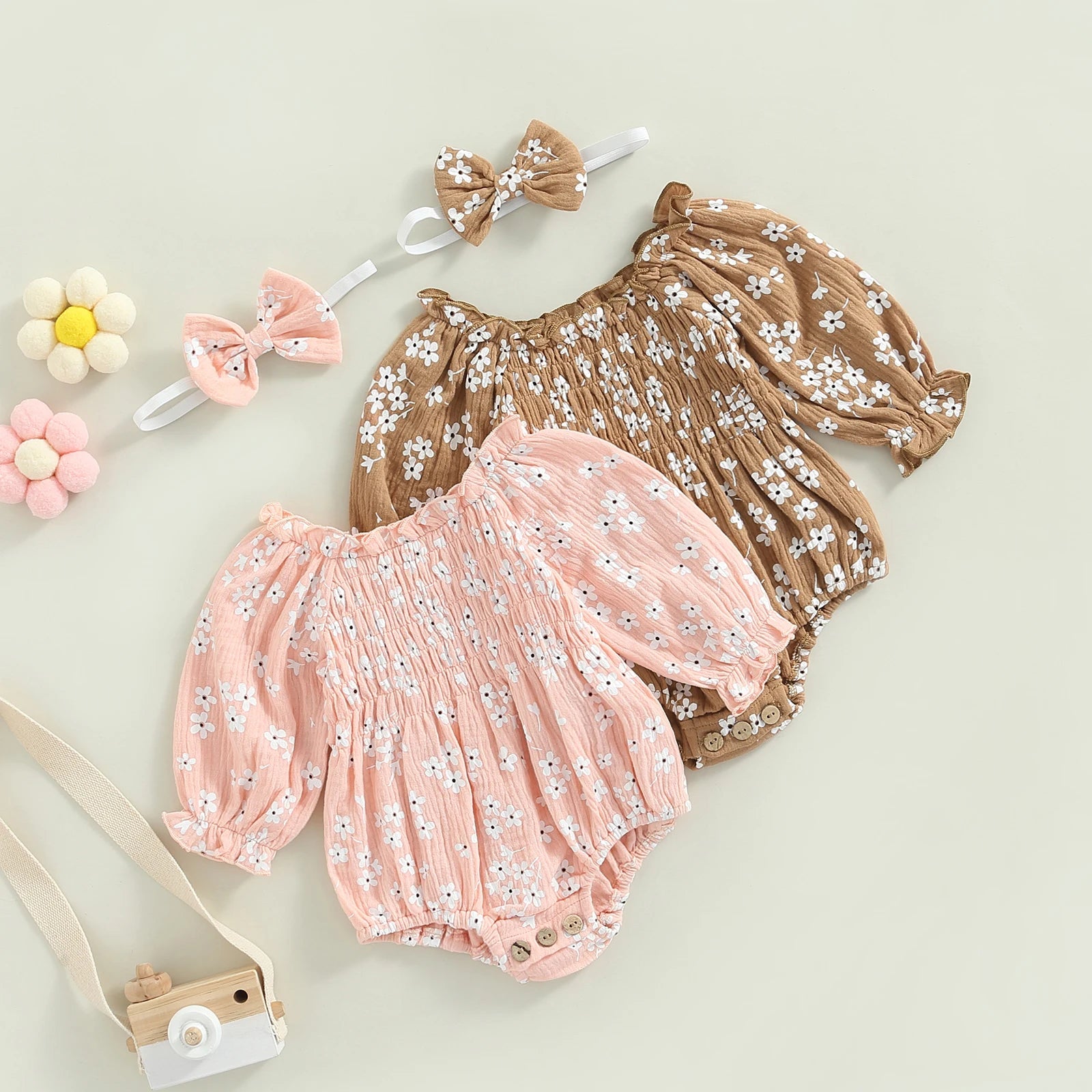 Adorable pink and tan floral baby rompers for girls, perfect boho outfits with puff sleeves and vintage charm.