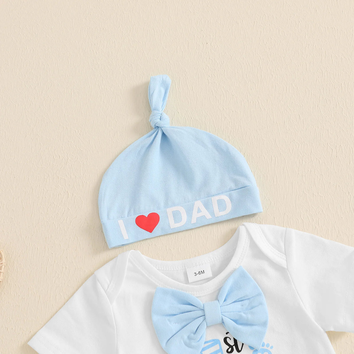 Light blue baby beanie hat with 'I ❤️ DAD' text, perfect for celebrating Father's Day.