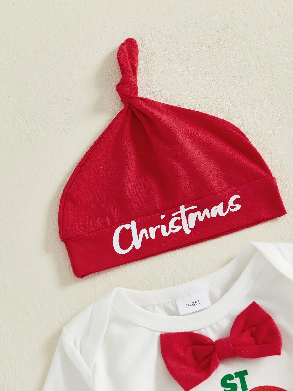 Red baby beanie hat with 'Christmas' text, part of My 1st Christmas Suspender Set for festive baby outfits.
