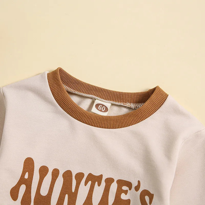 Close-up of the collar of the Auntie's Bestie Romper featuring retro lettering and contrasting brown neckline.