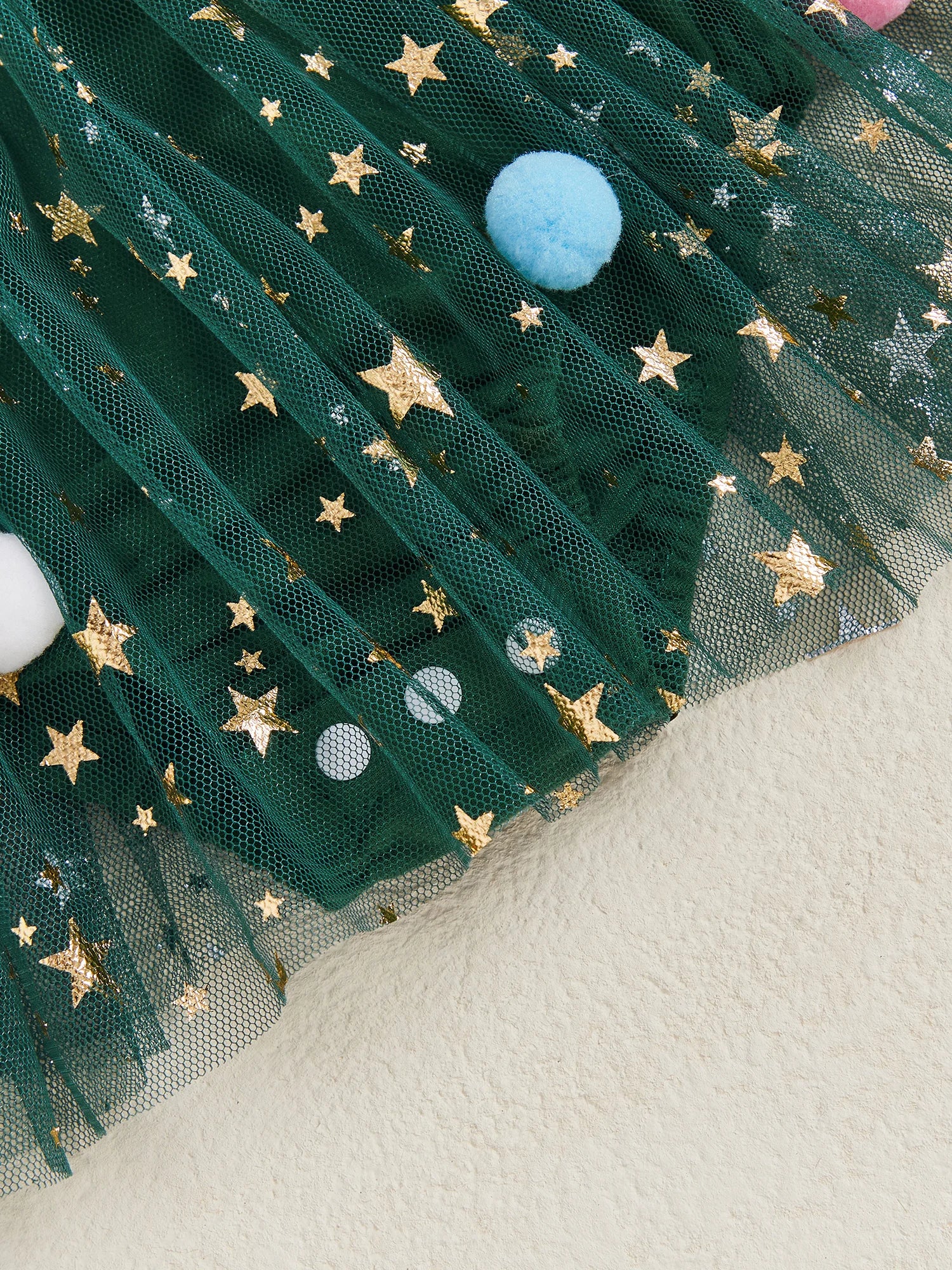 Glittery star mesh tutu skirt with colourful pom-poms for baby girl Christmas dress. Perfect for a memorable first Christmas outfit.