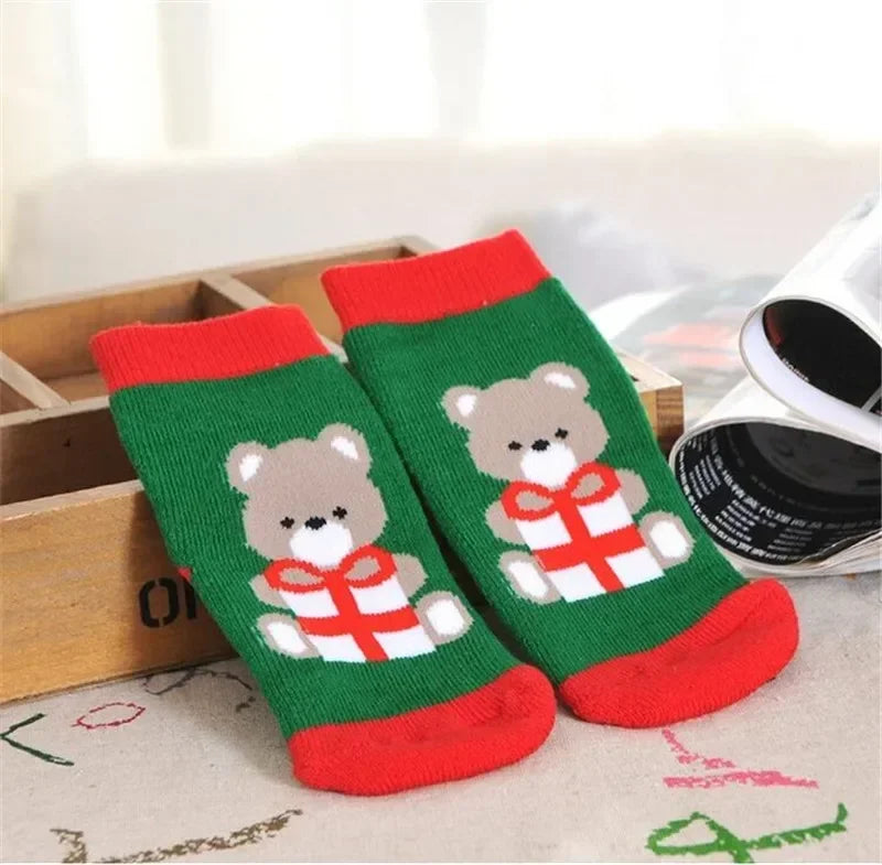 Baby Christmas Socks featuring a cute bear design holding a present, perfect for festive occasions.