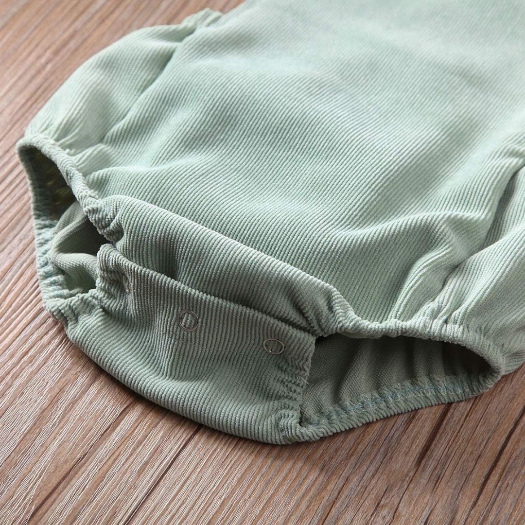 Closeup of corduroy baby romper showing snap buttons