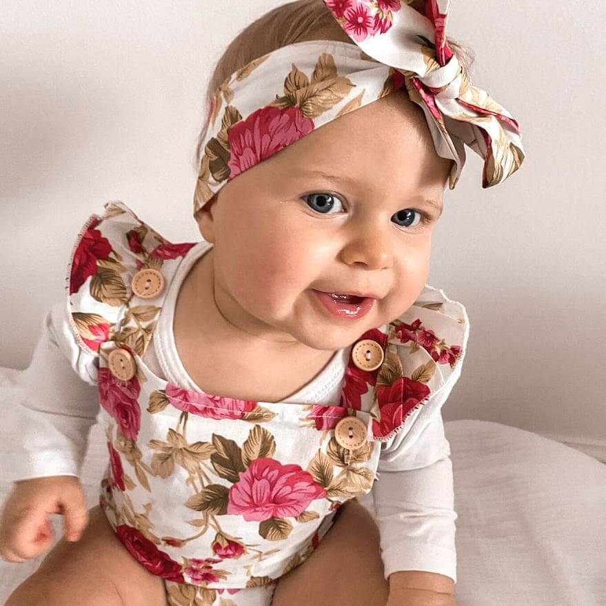 Baby girl wearing our Ava Pinafore Romper