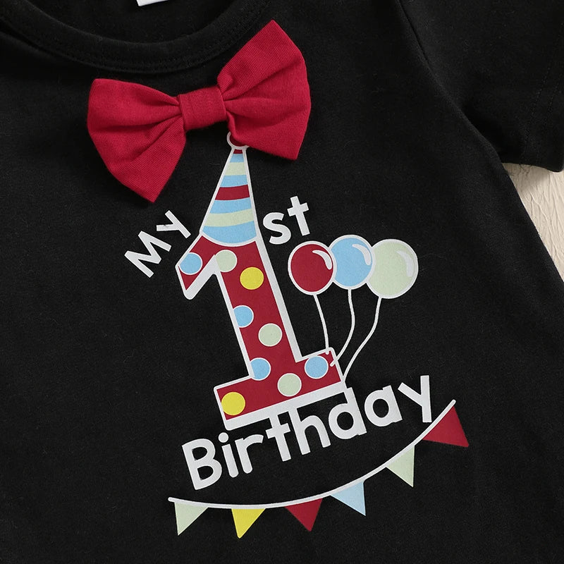 Baby boy first birthday outfit with bow tie and red suspender shorts - closeup of birthday design