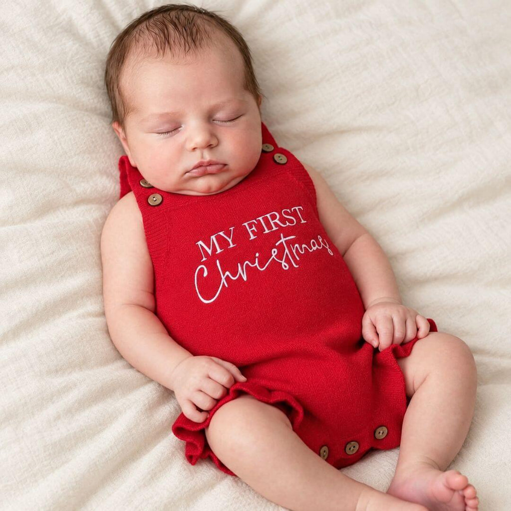 Baby asleep in a red My First Christmas romper from Lulu Babe